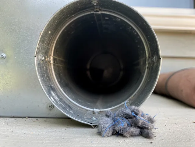 Milford Dryer Vent Cleaning technician using specialized equipment to clear severe dryer vent blockage in Milford
